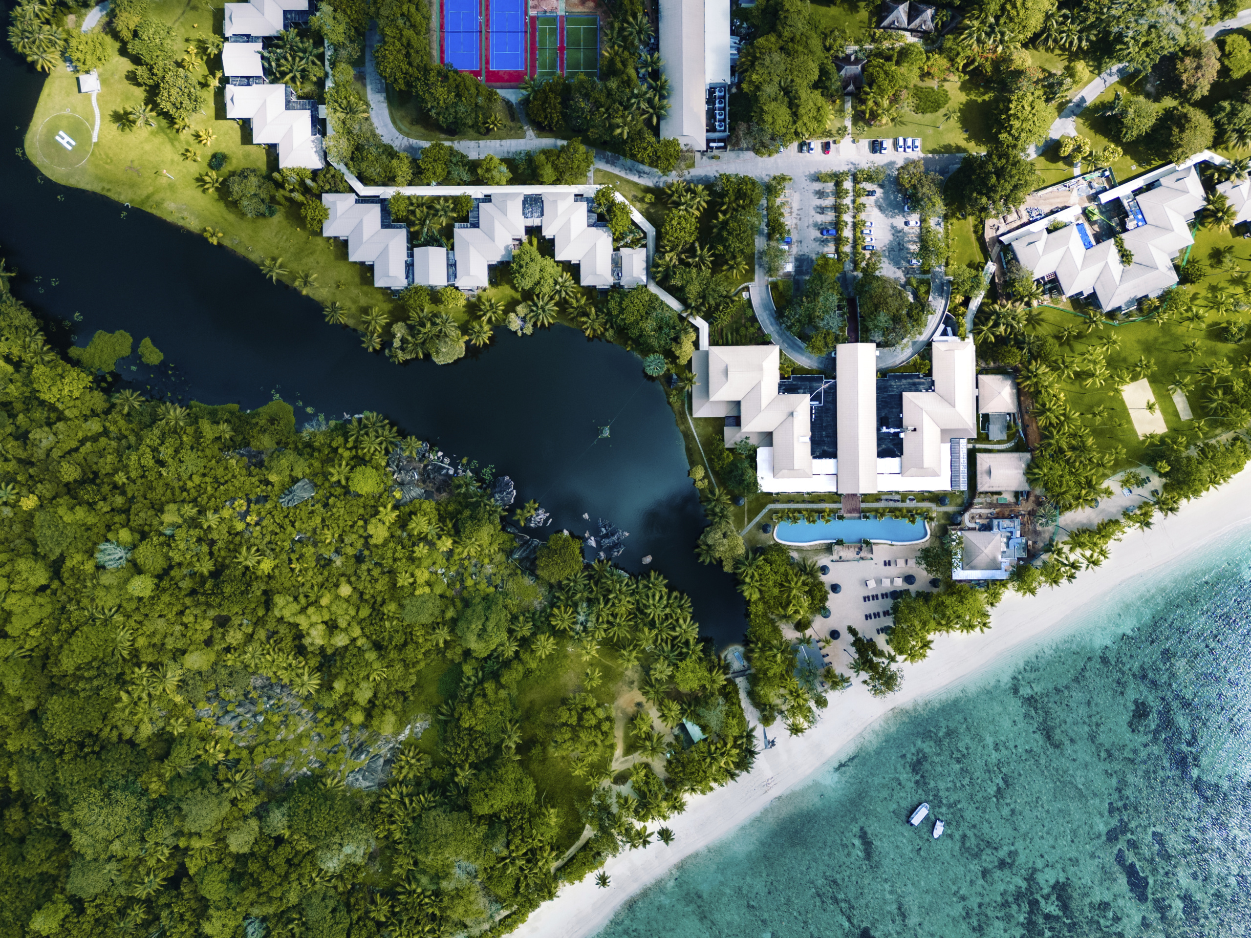 Aerial view of the resort with the ocean, laguna, pool and main area